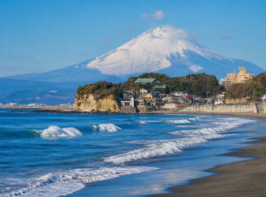 Kamakura beach with Mount Fuji and Enoshima on a clear day in Japan